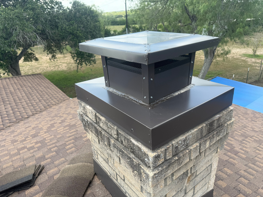 Dark cap on white/stucco chimney